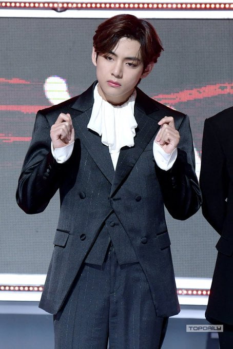 v in grey suit