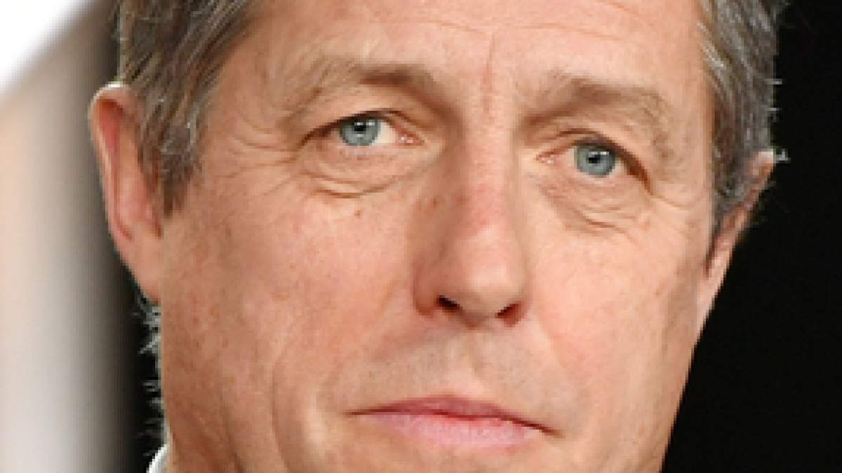 Hugh Grant Helps Serve Christmas Meal To 500 Elderly Residents In